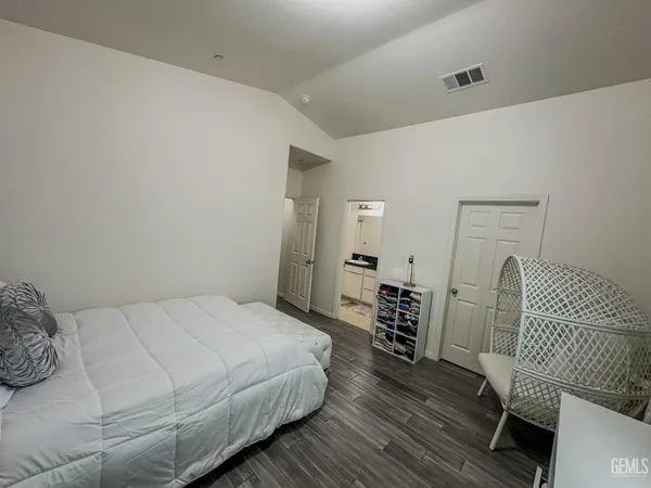 a bedroom with a bed and a chair