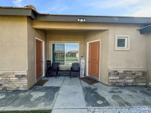 a view of a patio with table and chairs