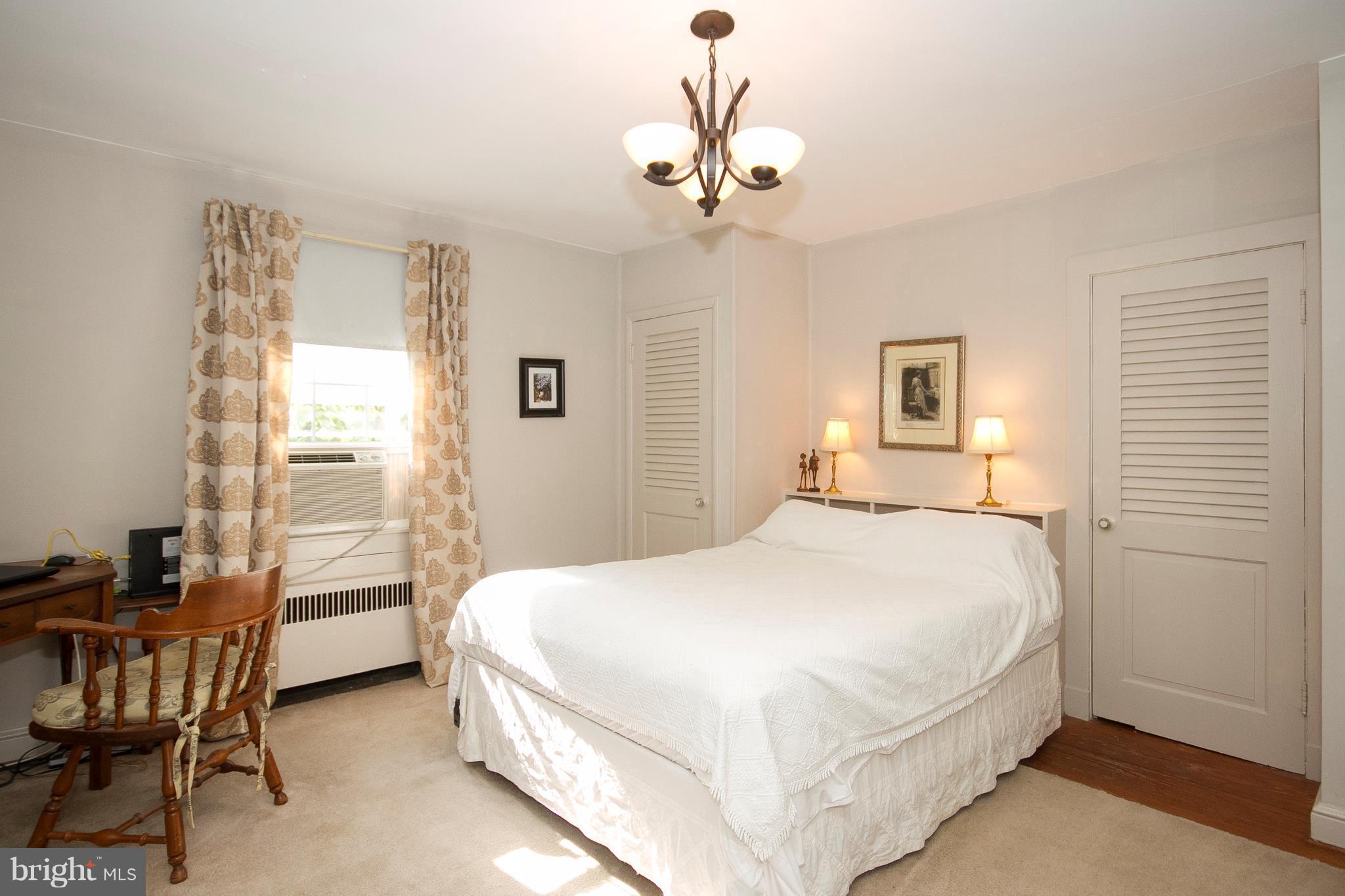 601 Dunkirk Road Baltimore, MD 21212 - Photo 12 of 22 a bedroom with a bed and a chandelier