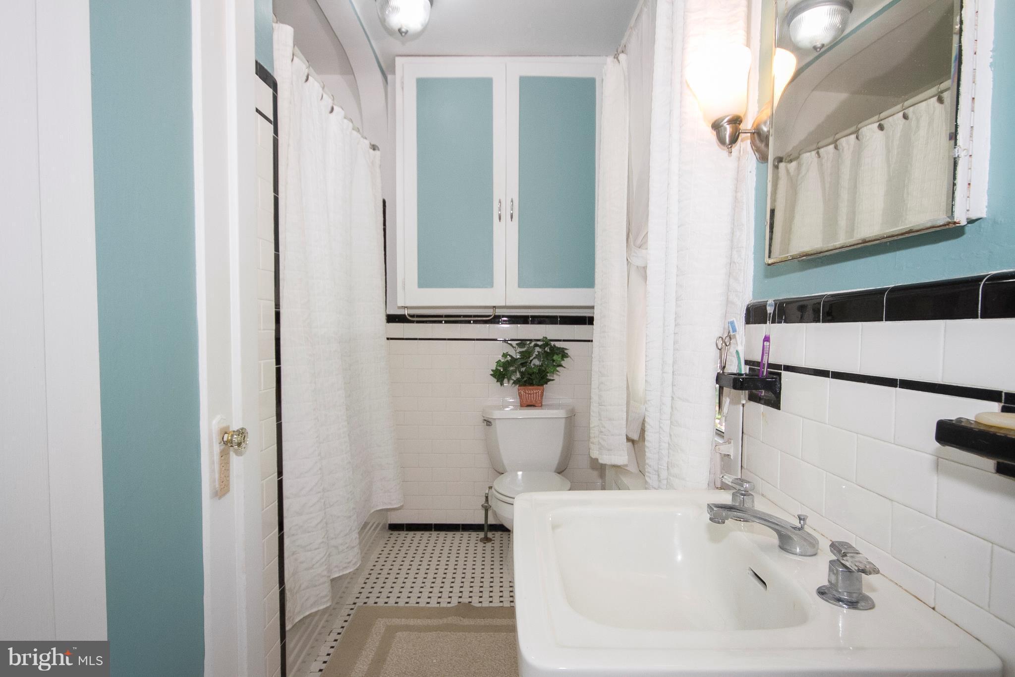 601 Dunkirk Road Baltimore, MD 21212 - Photo 14 of 22 a bathroom with a sink and a mirror