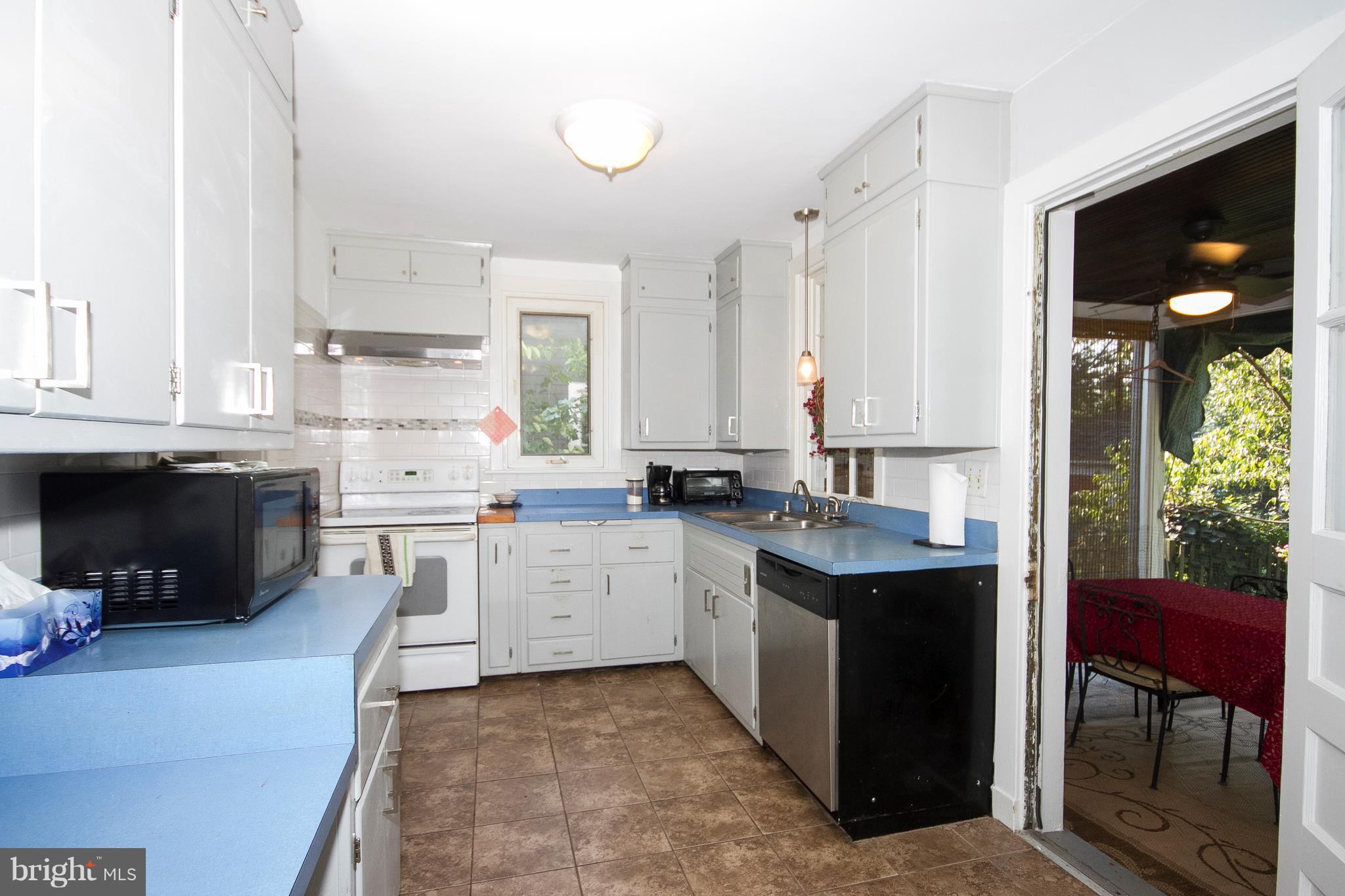 601 Dunkirk Road Baltimore, MD 21212 - Photo 5 of 22 a kitchen with a sink stove and cabinets