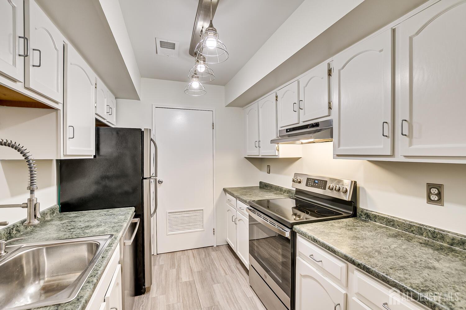 30-5 Prospect Street, Unit 2 Metuchen, NJ 08840 - Photo 13 of 23 a kitchen with stainless steel appliances granite countertop a sink stove and refrigerator