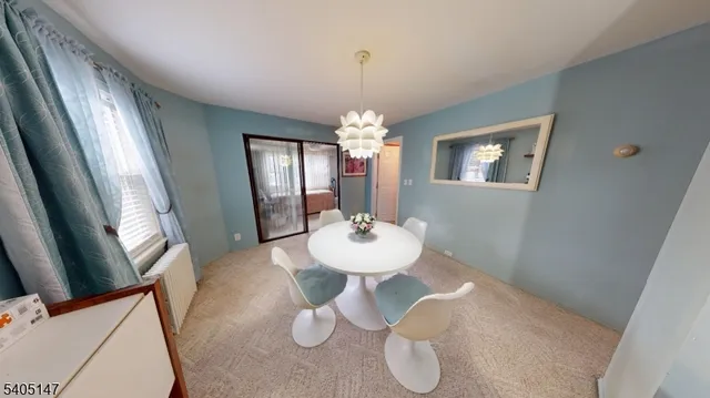a view of a dining room with furniture and window