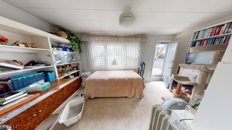 96 Rector Street Millburn, NJ 07041 - Photo 18 of 30 a bedroom with furniture and a book shelf