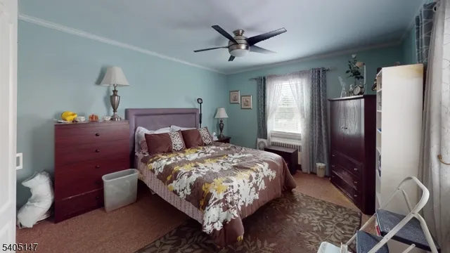 a bed sitting in a spacious bedroom next to a window