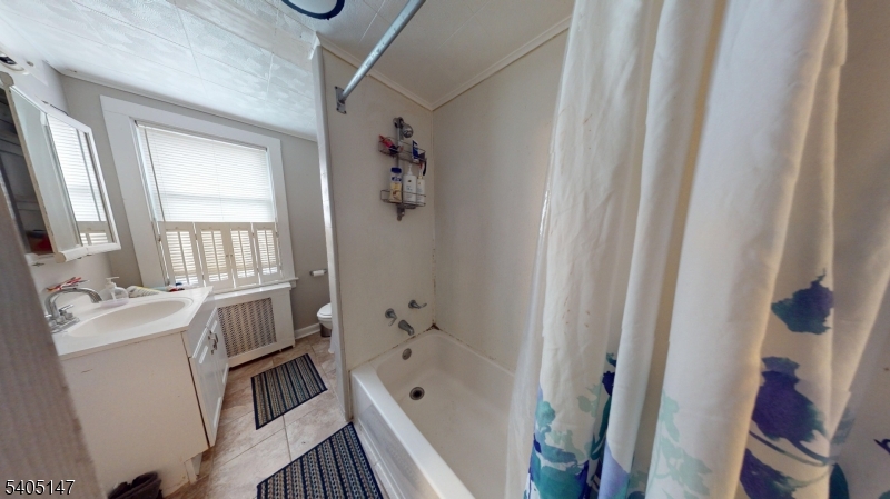 96 Rector Street Millburn, NJ 07041 - Photo 28 of 30 a bathroom with a sink a toilet a window and a mirror