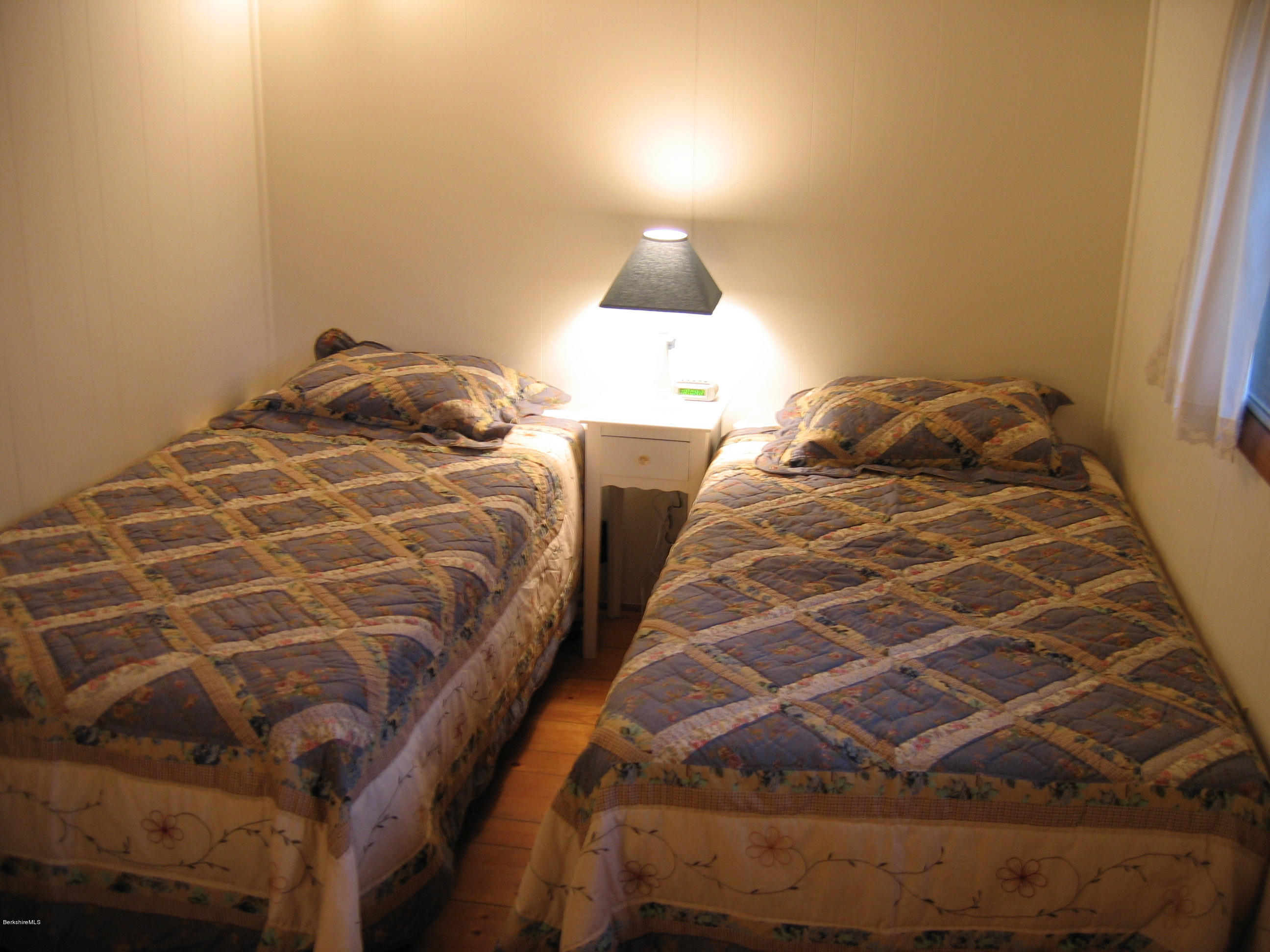 25 Sylvan Road Monterey, MA 01245 - Photo 12 of 17 a bedroom with a bed and a lamp