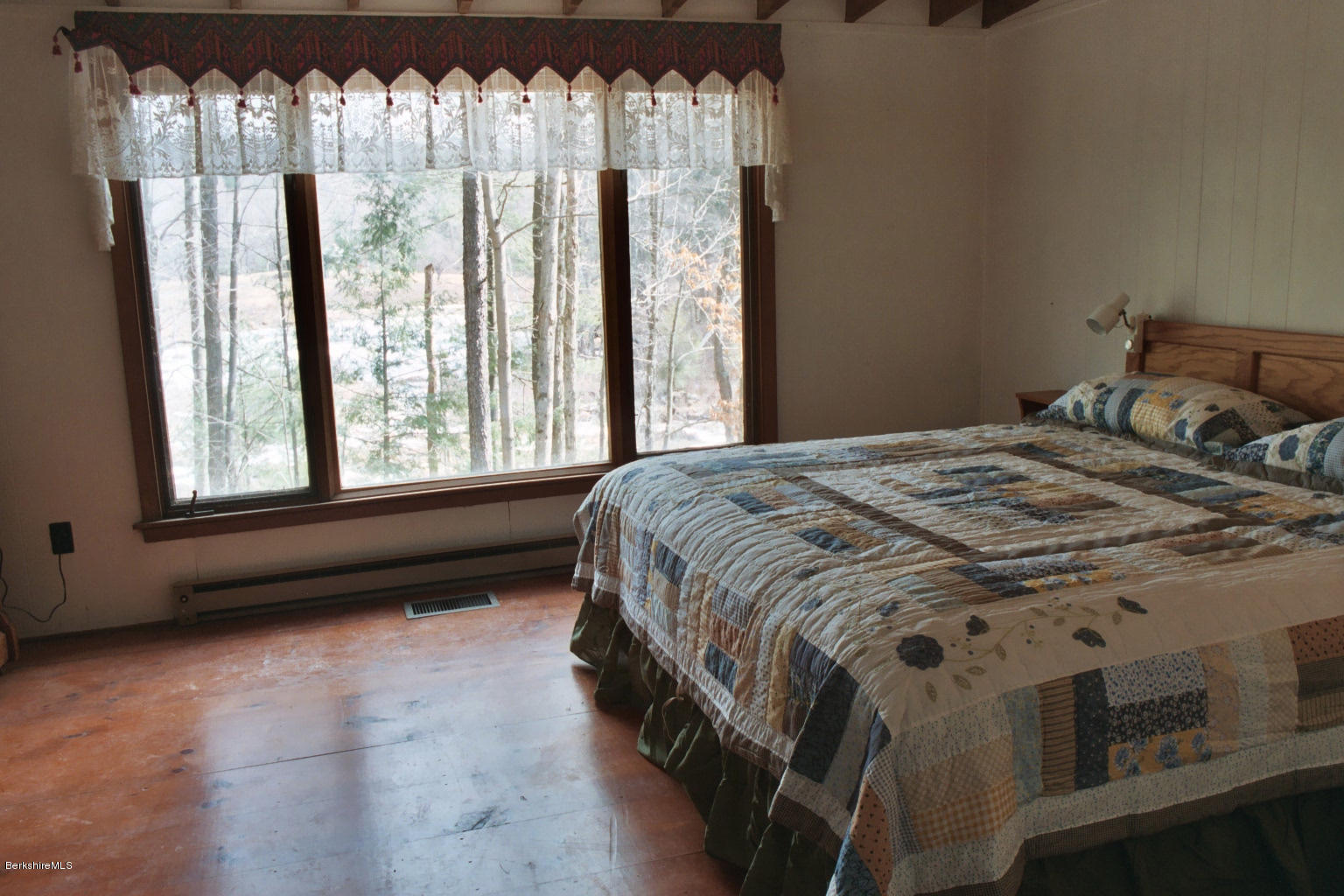 25 Sylvan Road Monterey, MA 01245 - Photo 8 of 17 a bed sitting in a bedroom next to a window