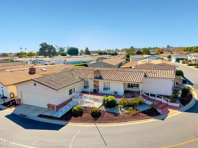 a roof deck with table and chairs and potted plants
