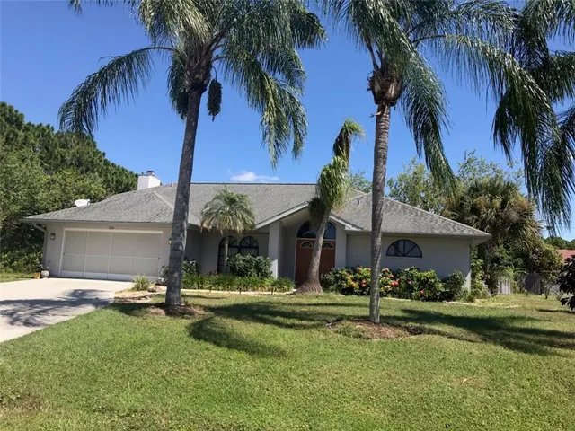 a front view of a house with swimming pool and porch with furniture