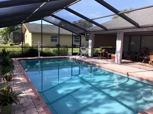 a view of a backyard with sitting area