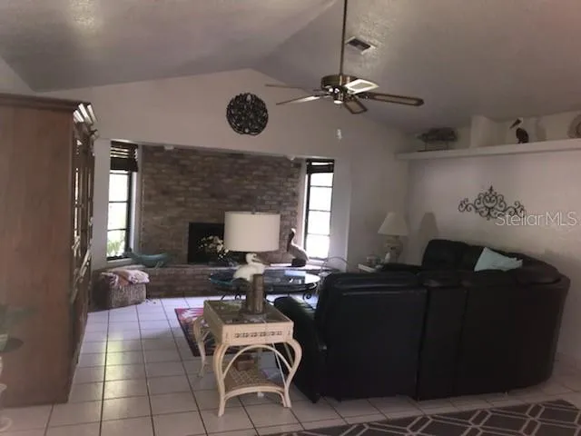 a living room with furniture a fireplace and window