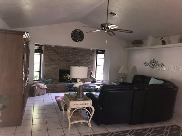 7160 Carlsbad Terrace Englewood, FL 34224 - Photo 7 of 19 a living room with furniture a fireplace and window