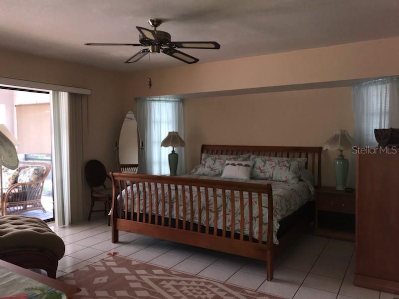 7160 Carlsbad Terrace Englewood, FL 34224 - Photo 9 of 19 a bed sitting in a bedroom next to a window