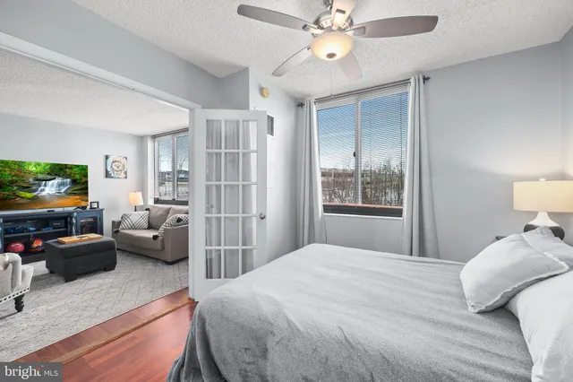 a bedroom with a bed furniture and a flat screen tv