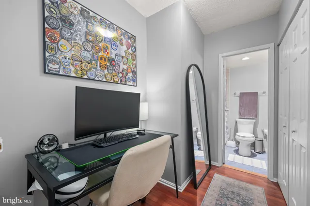 a view of a workspace with furniture and a gate