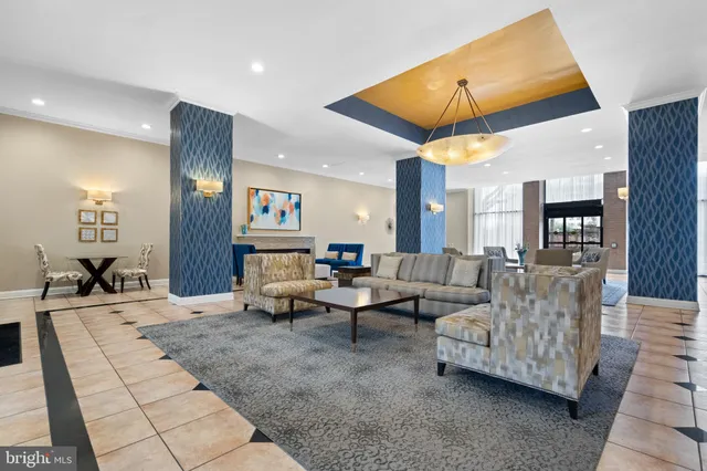a living room with furniture and kitchen view