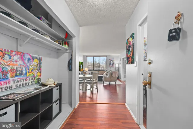 a view of a kitchen with furniture and wooden floor