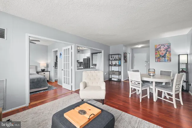 a living room with furniture and a wooden floor