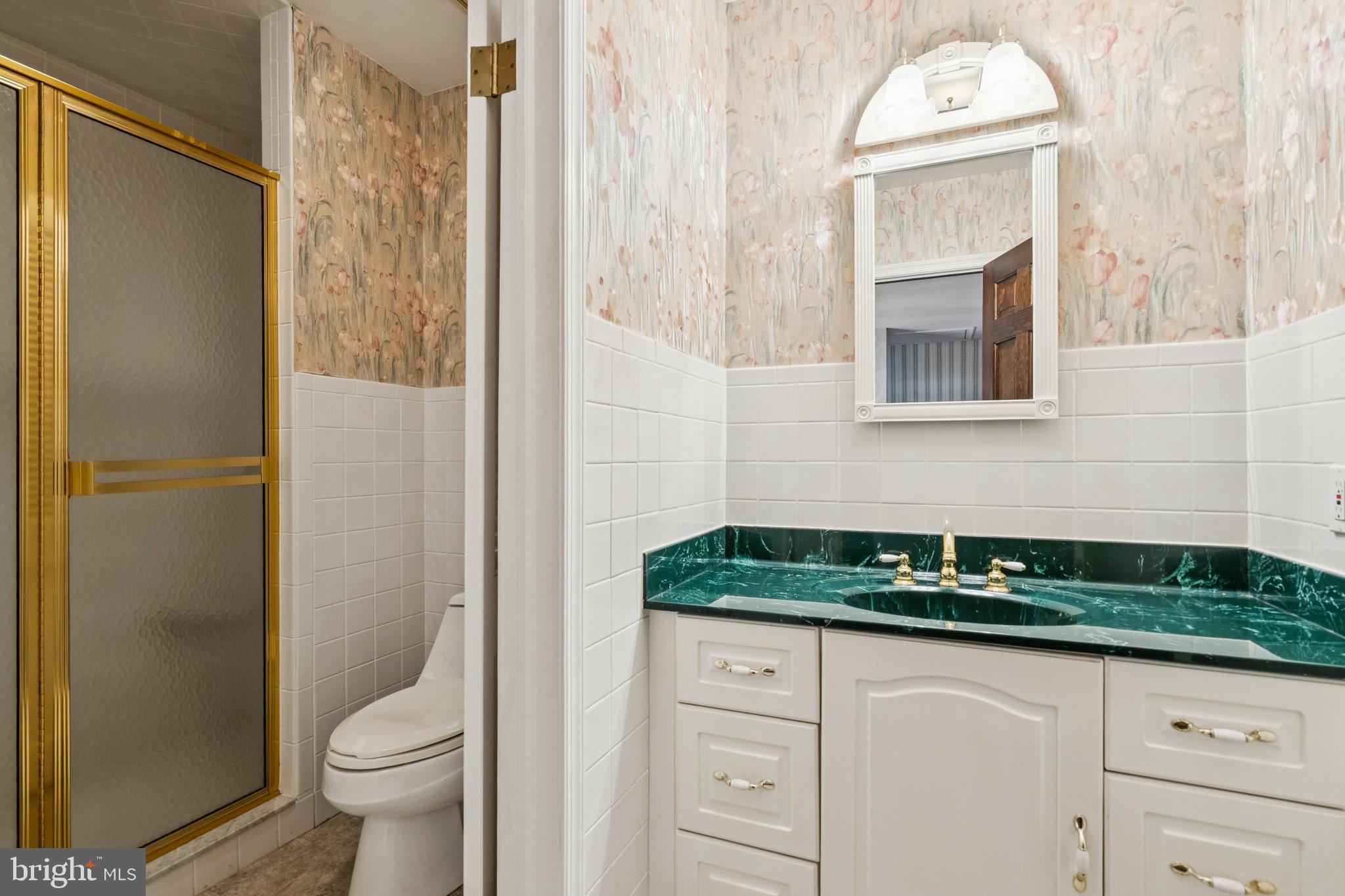 2 Oriole Way Moorestown, NJ 08057 - Photo 21 of 28 a bathroom with a granite countertop sink a toilet and shower