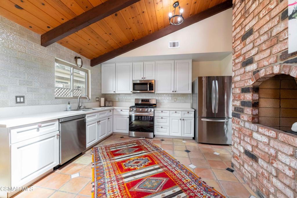 5121 Breakwater Way Oxnard, CA 93035 - Photo 11 of 54 a kitchen with a sink stainless steel appliances and cabinets