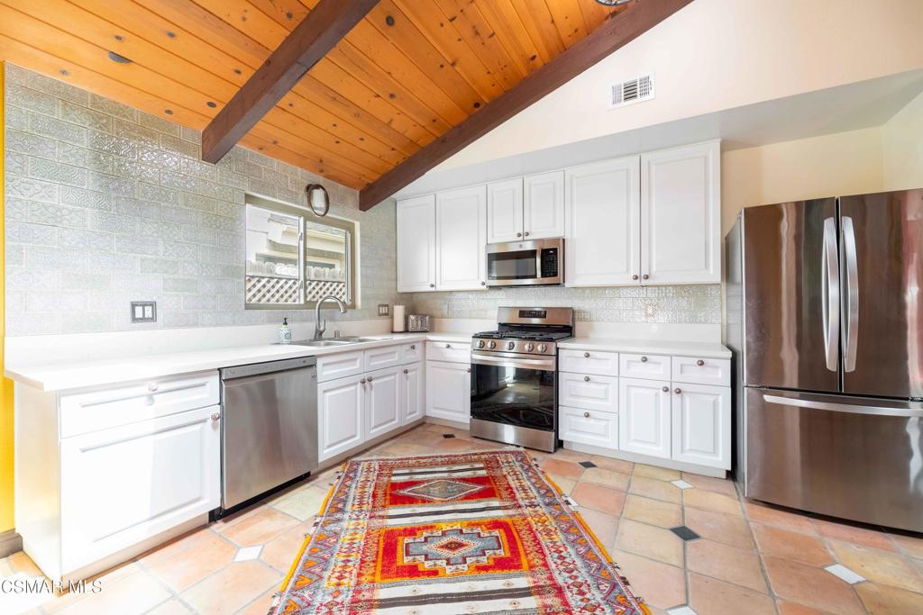 5121 Breakwater Way Oxnard, CA 93035 - Photo 12 of 54 a kitchen with stainless steel appliances granite countertop a sink stove refrigerator and cabinets