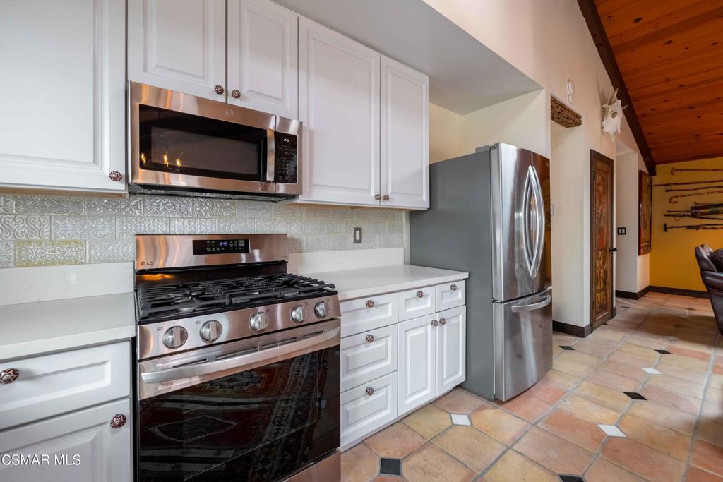 5121 Breakwater Way Oxnard, CA 93035 - Photo 13 of 54 a kitchen with stainless steel appliances granite countertop a stove a refrigerator and a microwave