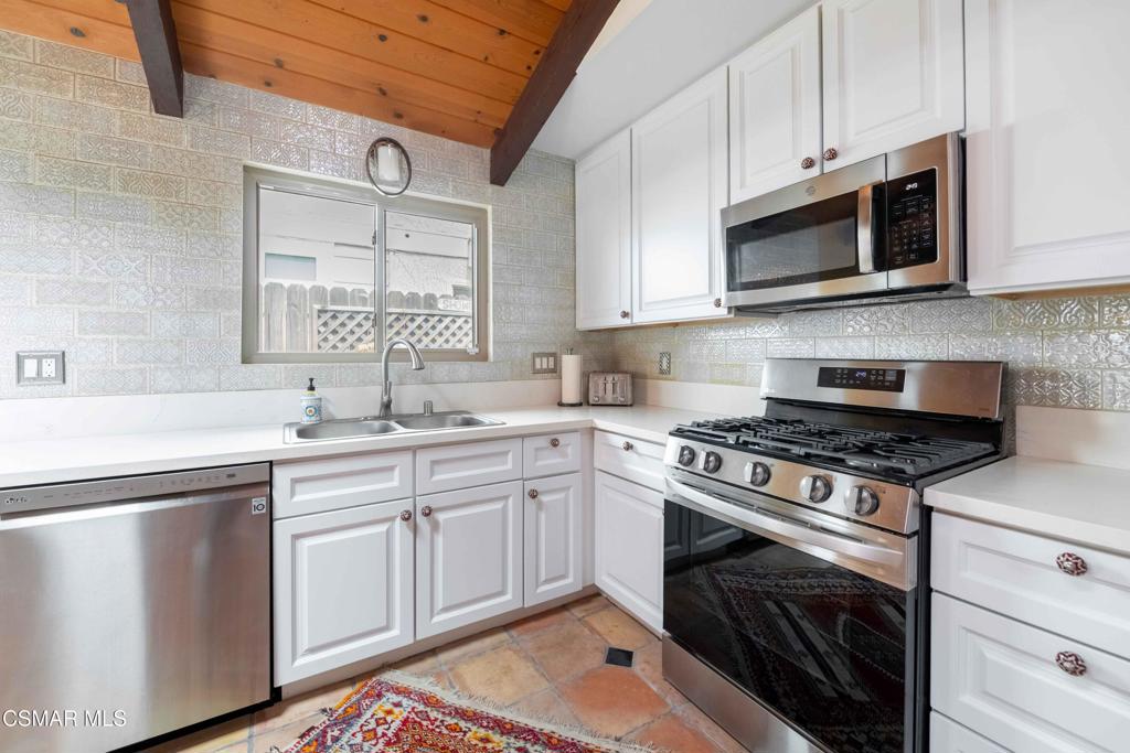 5121 Breakwater Way Oxnard, CA 93035 - Photo 14 of 54 a kitchen with white cabinets and appliances