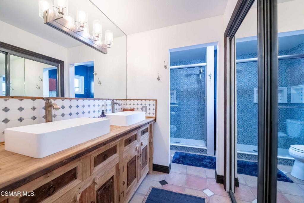 5121 Breakwater Way Oxnard, CA 93035 - Photo 26 of 54 a bathroom with a sink a mirror and a shower