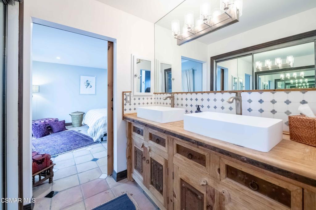 5121 Breakwater Way Oxnard, CA 93035 - Photo 27 of 54 a spacious bathroom with a granite countertop sink and a mirror