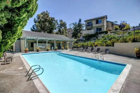 a view of a house with swimming pool and sitting area