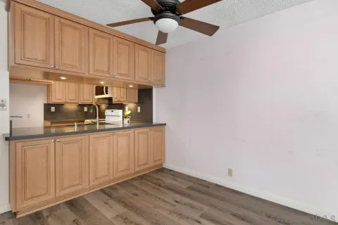 a kitchen with cabinets appliances and a counter space