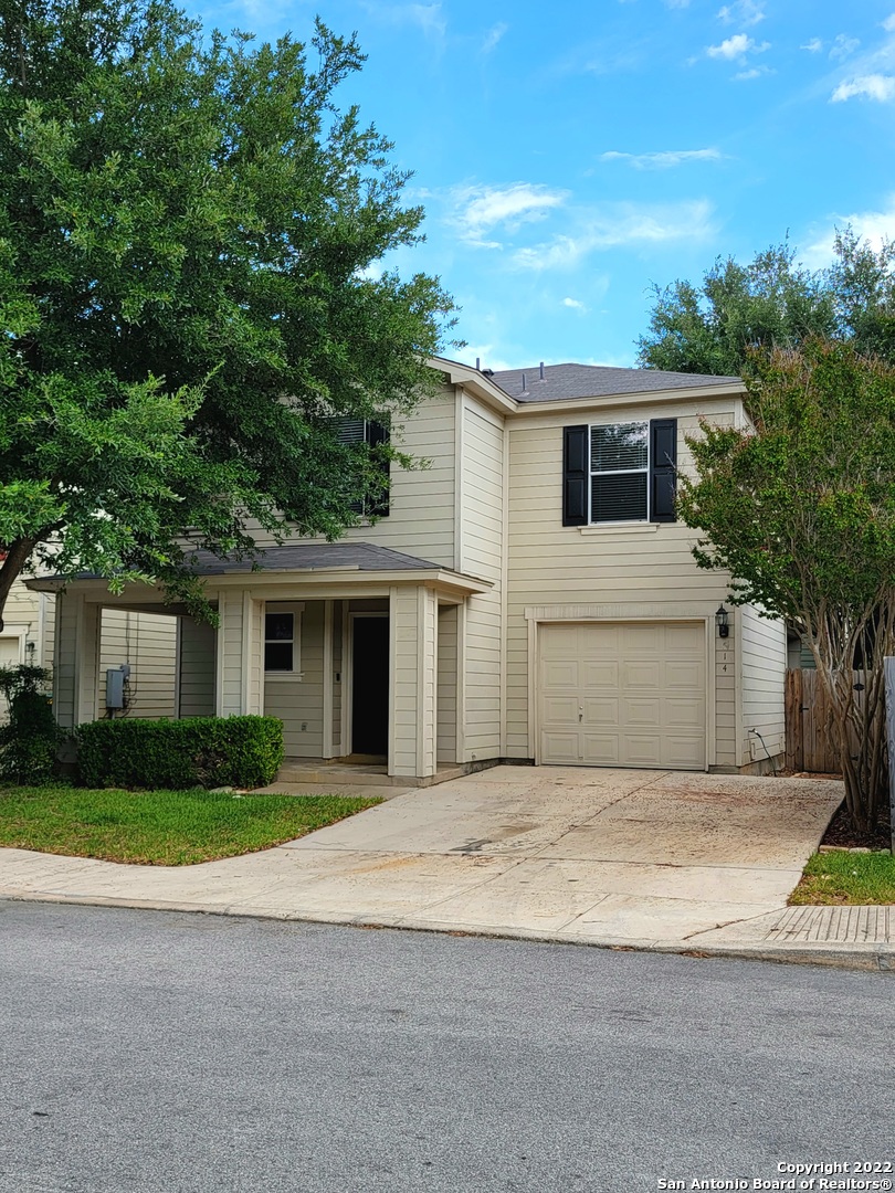 a front view of house with yard and trees