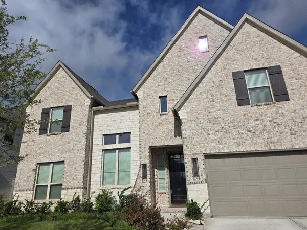 a front view of a house with garage