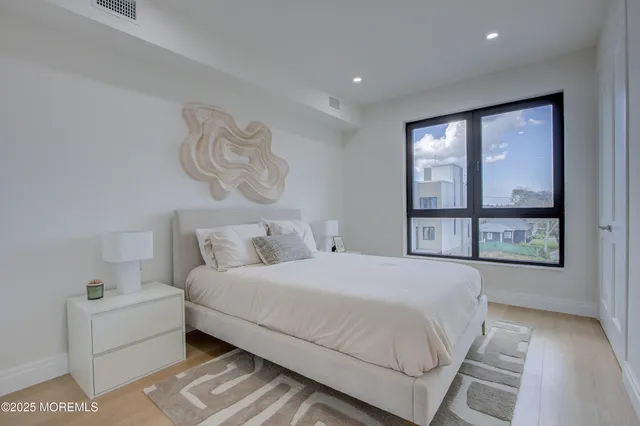 a bedroom with a large bed and a large window