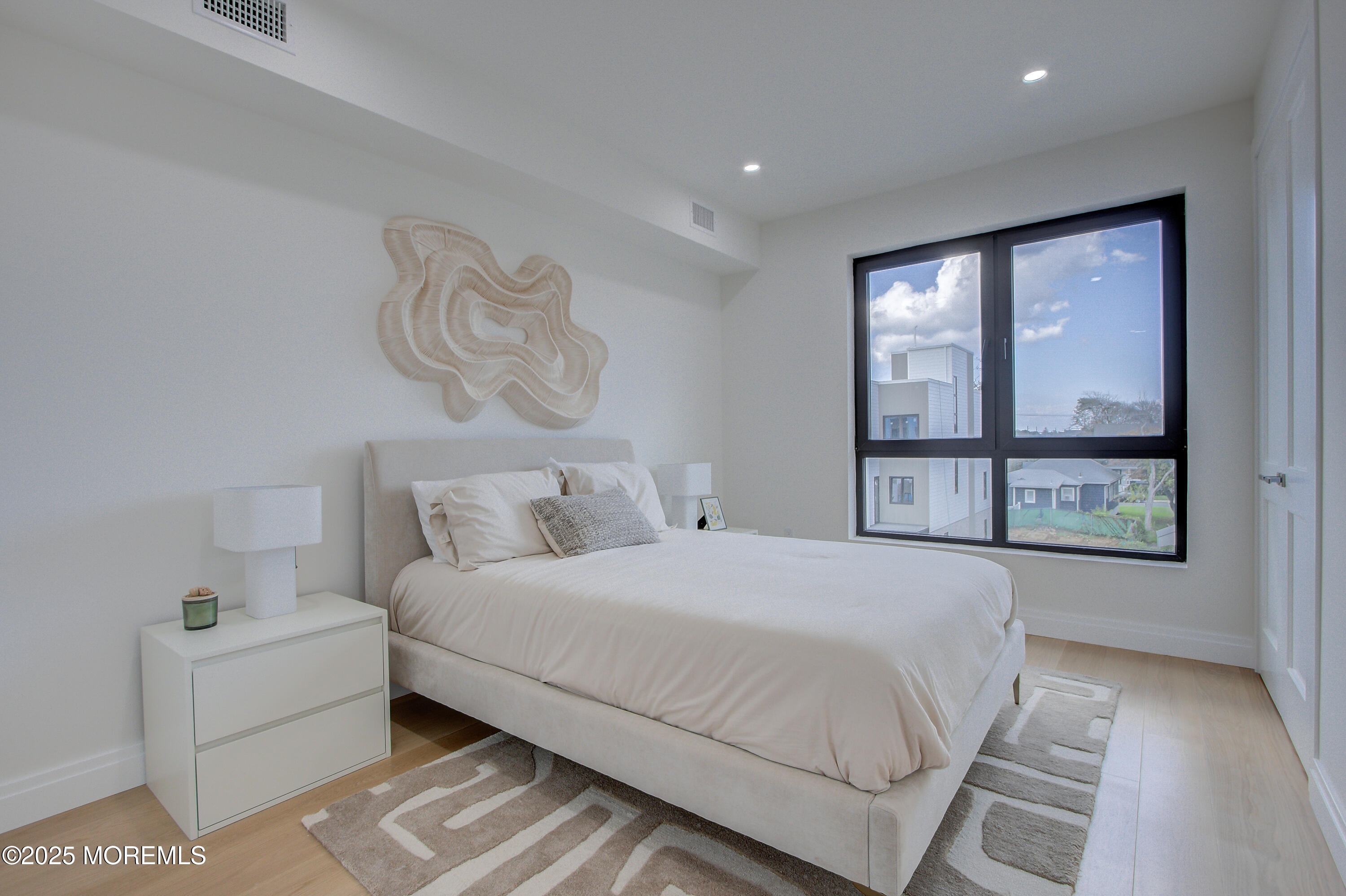 4 Seashore Drive Long Branch, NJ 07740 - Photo 24 of 34 a bedroom with a large bed and a large window