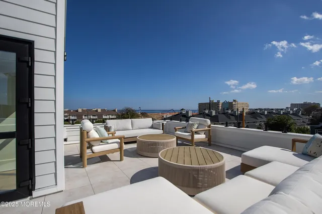 a terrace with outdoor seating and couches