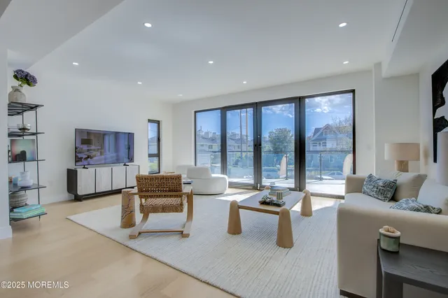 a living room with furniture and large window