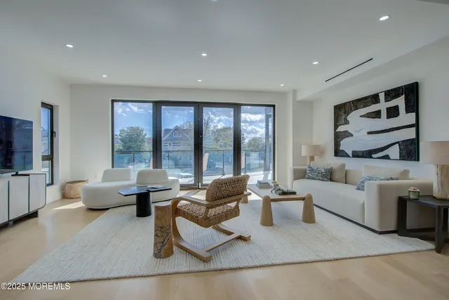 a living room with furniture and large window