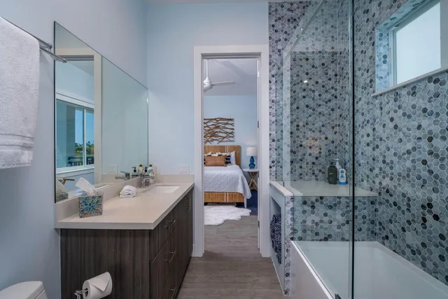 a bathroom with a sink a toilet and shower