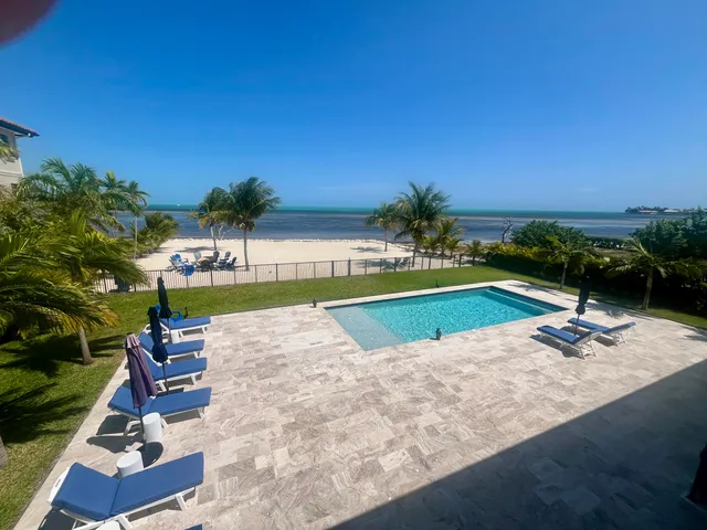 a view of a house with swimming pool and sitting area