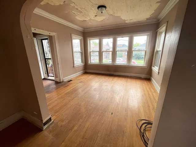 wooden floor in an empty room with a window
