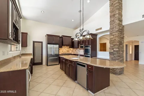 a large kitchen with stainless steel appliances kitchen island granite countertop a sink counter space and stainless steel appliances