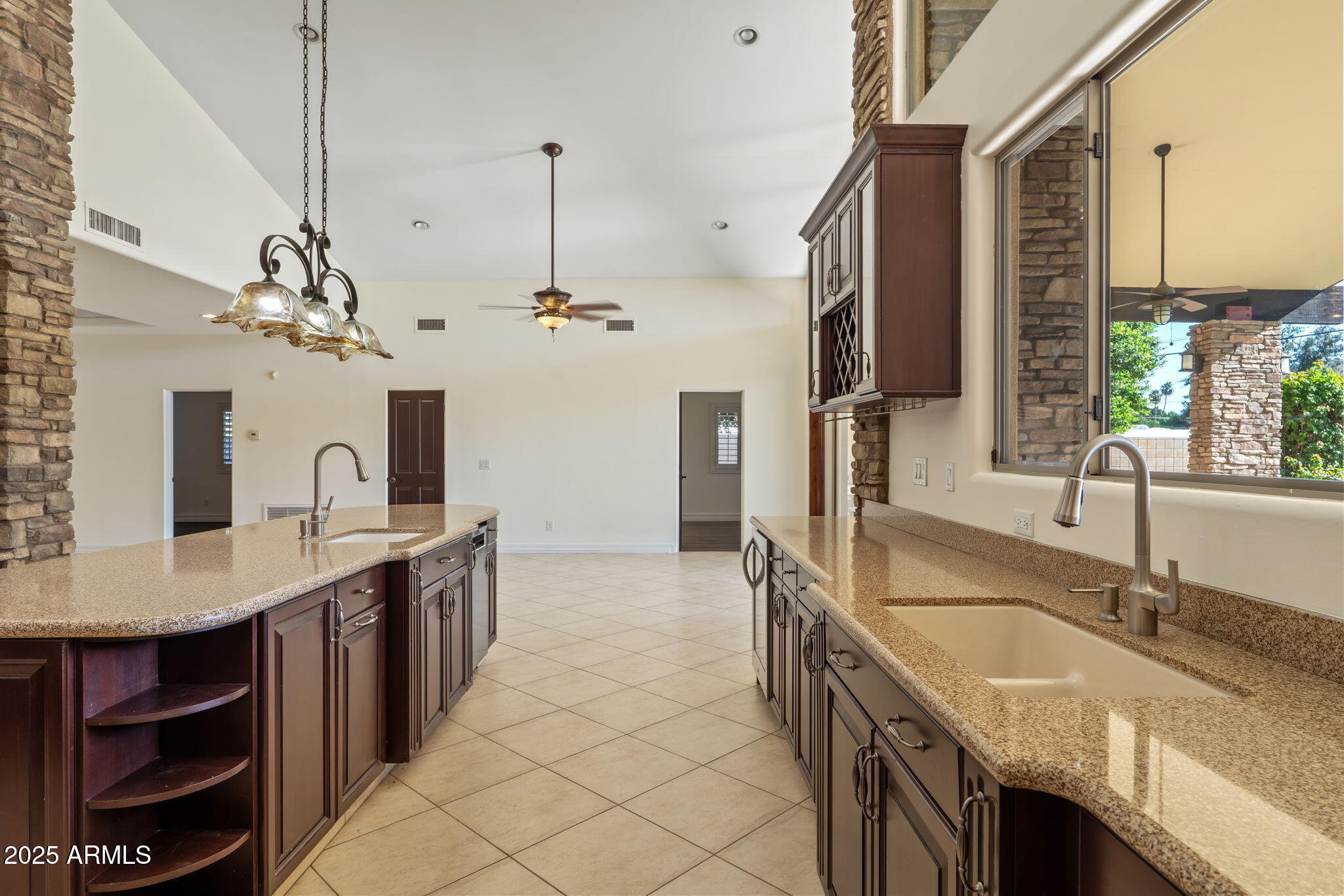1435 East Rancho Drive Phoenix, AZ 85014 - Photo 18 of 52 a kitchen with kitchen island granite countertop a sink a counter top space and cabinets