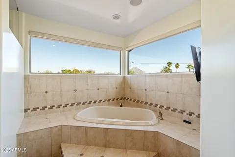 a bathroom with a bathtub and a shower