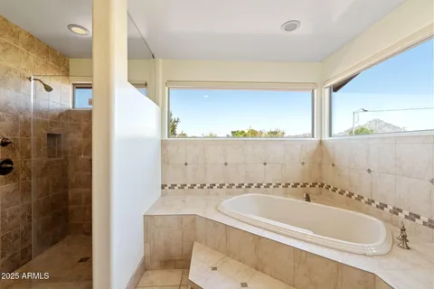 a bathroom with a granite countertop double vanity sink mirror and double