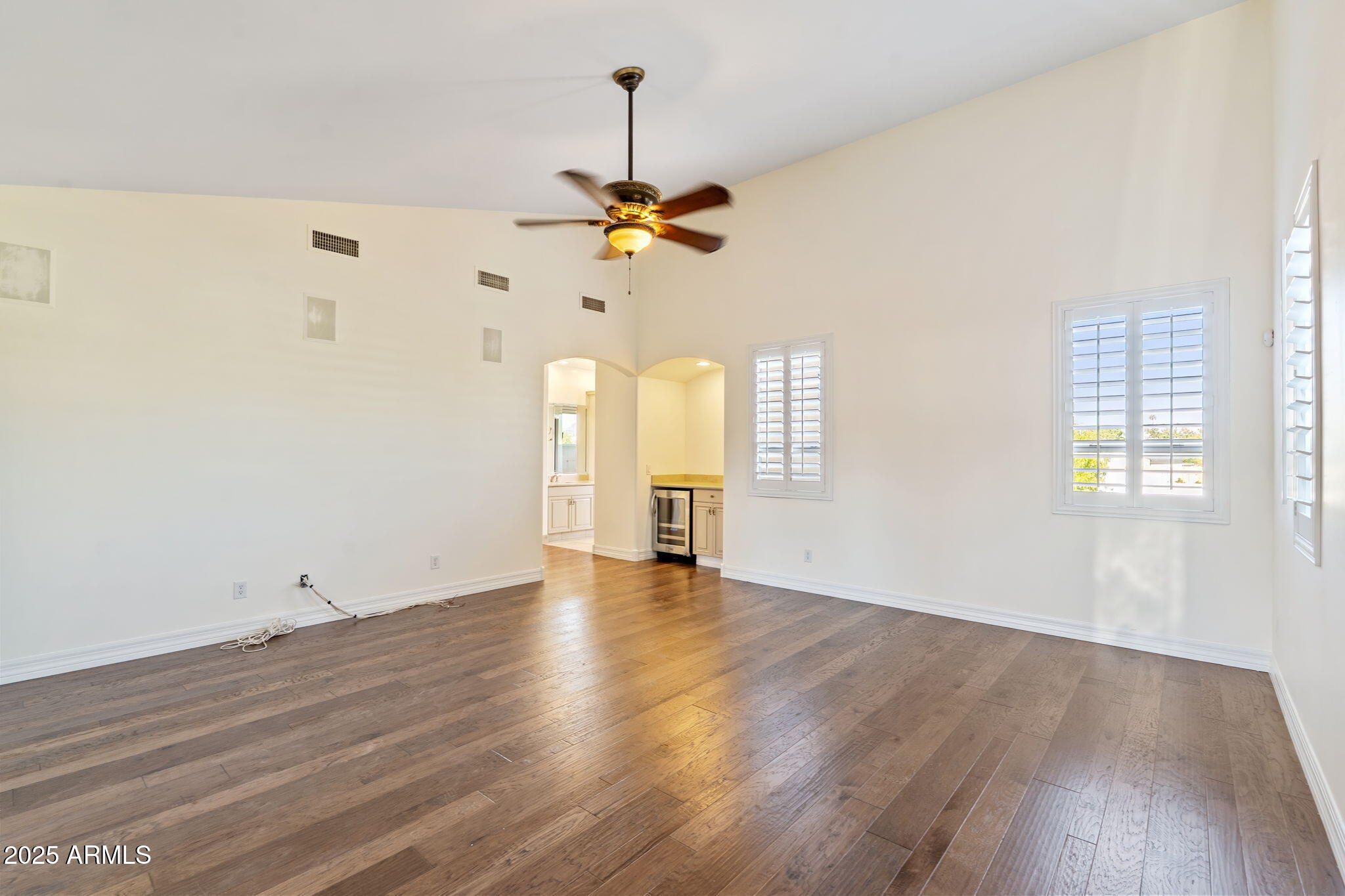 1435 East Rancho Drive Phoenix, AZ 85014 - Photo 39 of 52 a view of a room with wooden floor ceiling fan and window
