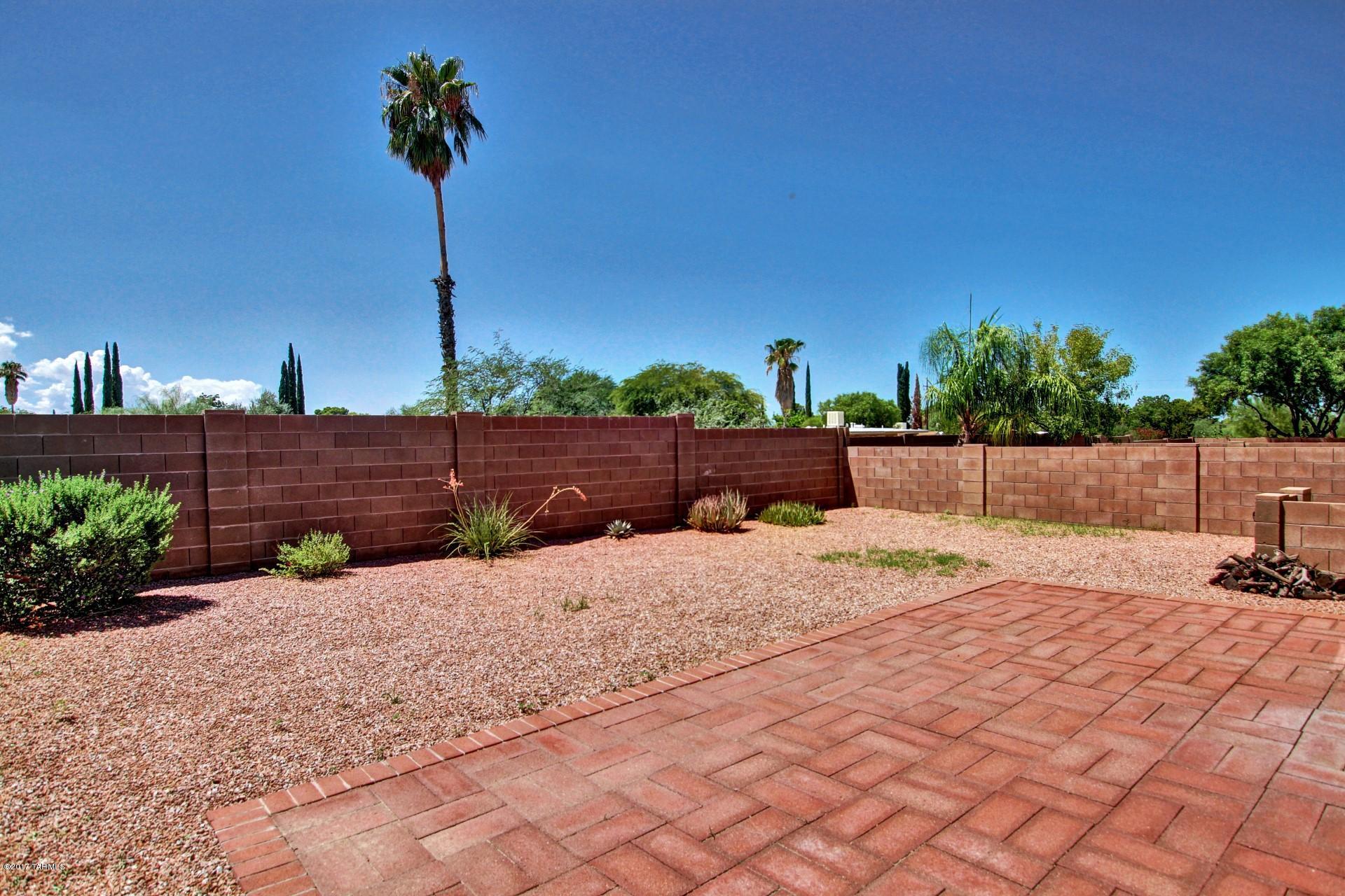 8350 East Bowline Road Tucson, AZ 85710 - Photo 23 of 26 a street view with a garden