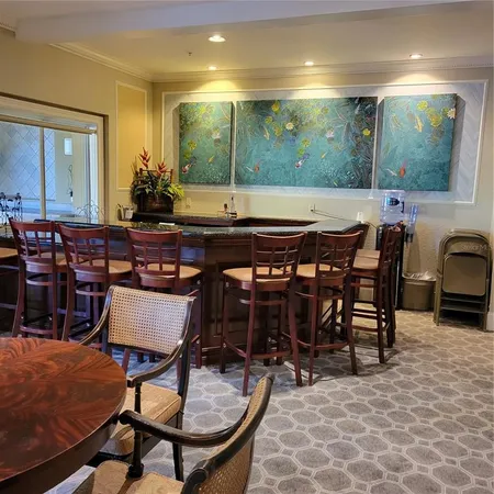 a kitchen with granite countertop a table and chairs in it
