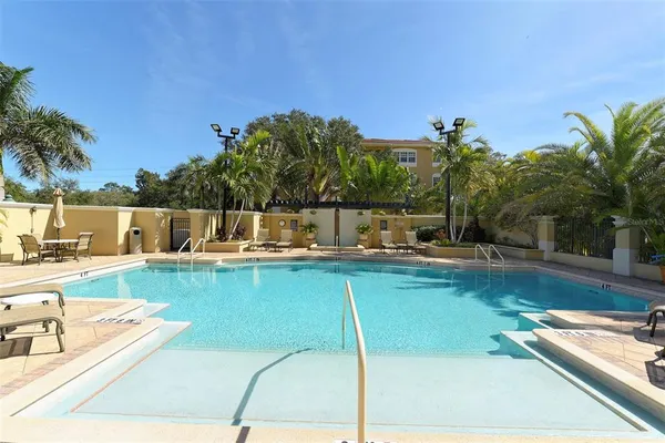 a swimming pool with outdoor seating and yard